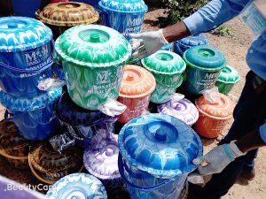 Hand washing buckets with spigots and lids being distributed to the villagers of Ngolahun.