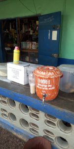 The owner of this local store is providing an important hand-washing station for the many customers she serves.